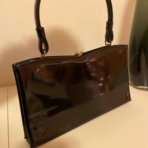 VINTAGE: black, small handled, shiny purse. Good condition, made in the USA